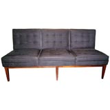 Armless sofa in in black ultra suede.