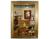 Large stepped gold-leaf framed mirror by Karl Springer
