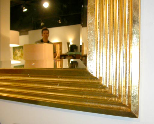 Large stepped gold-leaf framed mirror by Karl Springer