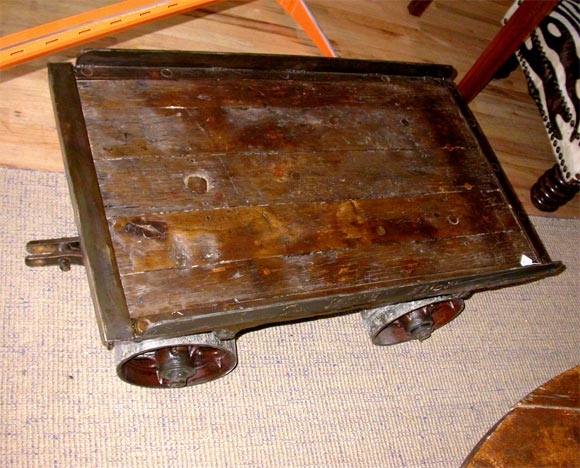 Industrial Cart with chunky iron wheels and top made from old railroad ties.  c. 1940's.  Additional larger carts available. Call for photo.