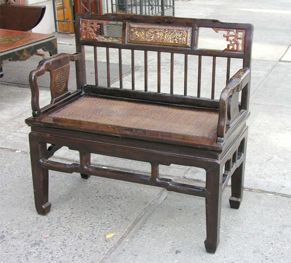 An Antique Chinese carved and 2 seat bench with hand woven basket weave seat.