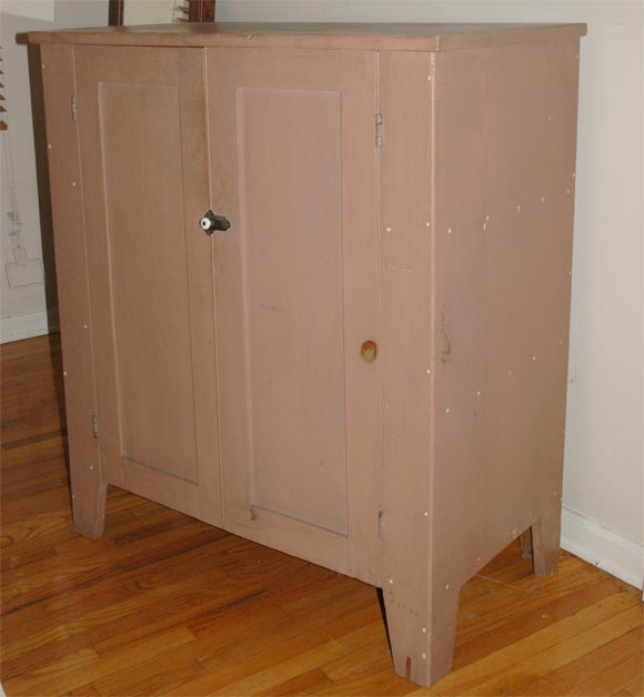 19THC ORIGINAL SALMON PAINTED JELLY CUPBOARD WITH GREAT CUT OUT FEET AND ALL ORIGINAL HARDWARE & CUT NAIL CONSTRUCTION/THE INTERIOR HAS THREE SHELFS/ FOUND IN YORK COUNTY , PENNSYLVANIA