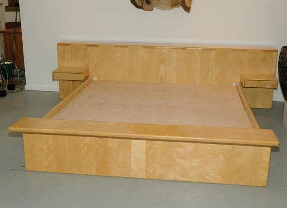 Very large scale platform bed w/built in night tables with drawers. Head and footboard are cantelievered with brackets to adjust for thick or thin king size matresses. Designed by Gerald McCabe.
