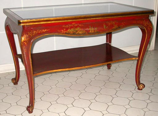 French Japanese coffee table by Maison Jansen. Black mirrored top over a two-tiered red and gilt body. Late 1930's.
