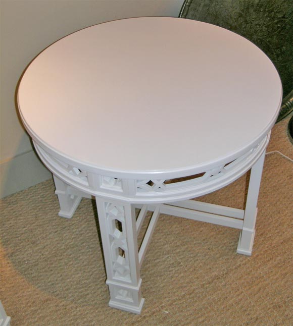 Pair of round white painted side tables in the Chippendale style