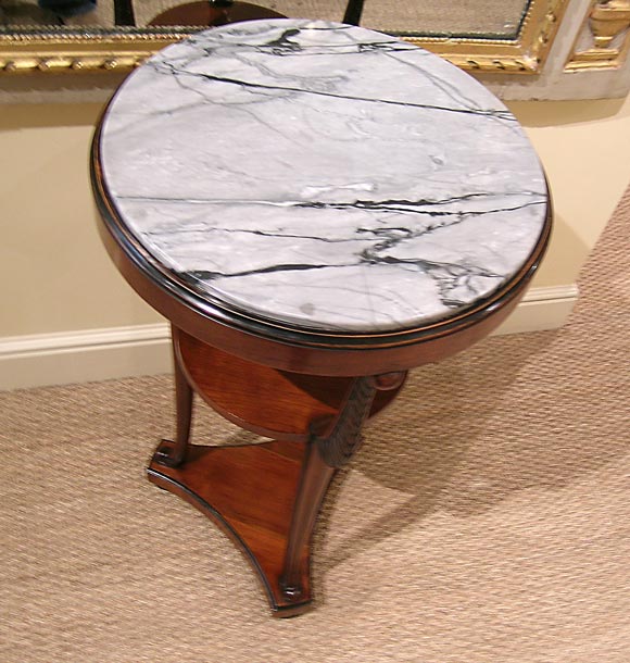 A Biedermeier Parcel Ebonized Walnut Gueridon
