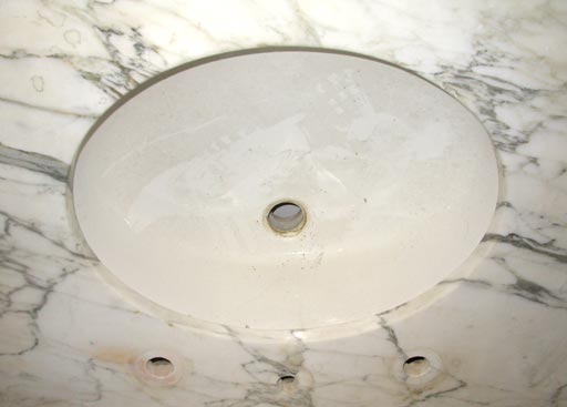 oval sink with marble countertop