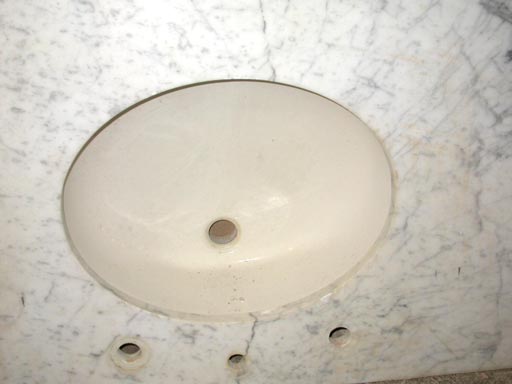 oval sink with marble countertop