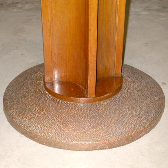A side table, design attributed to Josef Hoffmann and work he did for J.& J. Kohn in 1905, executed in oak having a circular top supported on a single pedestal having incurved sides; the base clad in hammered copper. Secessionist period, Vienna,