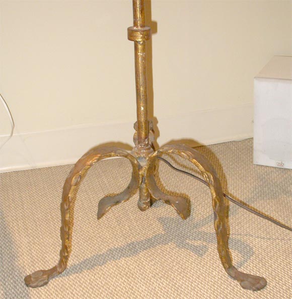 Wrought iron lamp with original gilded finish.  Lamp has a trident form candelabra base and a pierced Jade finial.  Recently rewired.