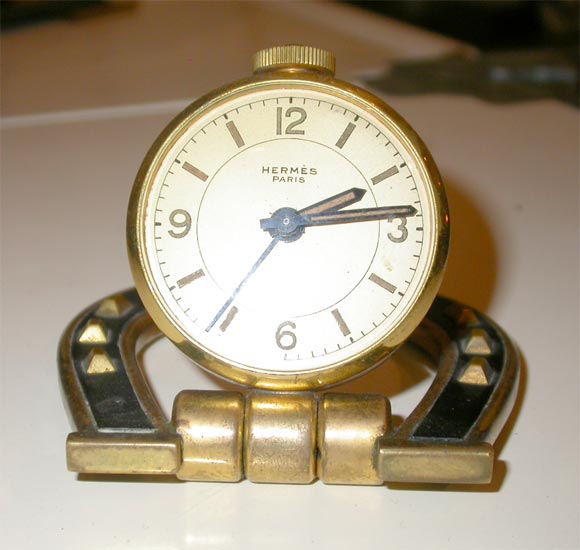 This is a 1930's Hermes Horseshoe Alarm Clock with original case.  Its brass & leather.