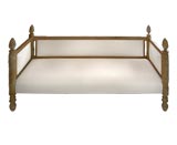 Setttee of carved wood and upholstered in white linen.