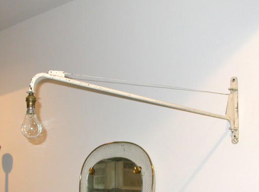 Rare white painted metal wall lamp with exposed bulb.