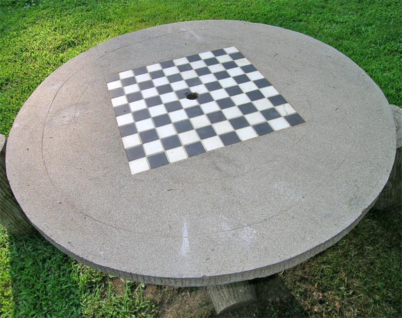 Outdoor pedestal table with inlaid checkerboard. Five 