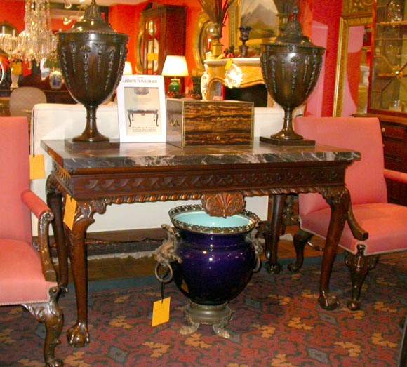 Irish Georgian mahogany marble topped console table. Vetruvian scroll frieze with scalloped apron and centered scalloped shell. Cabriole legs with carved shell on knee ending in ball and claw feet. Early 19th century.