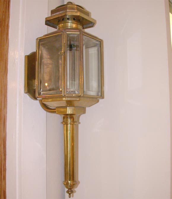 Brass carriage lamp featuring beveled glass windows