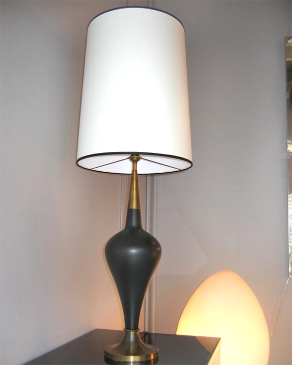 Black ceramic lamp with golden brass foot and neck. Lamp-shade dimensions: height 60 cm., diameter 37 cm.