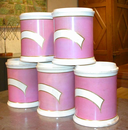 A set of five pink glazed porcelain apothecary jars. Formerly with lids.