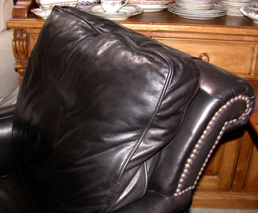 Black leather armchair, back cushion attached, down feather seat cushion, available in other leathers and fabric, nailhead trim.