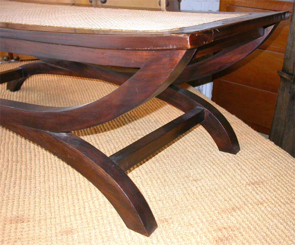 Elegant and Sober Bench made of Teak and Hand-caned. The frame is composed of intersecting arcs that supports the hand-caned seat. Origin: French Consulate, Saigon