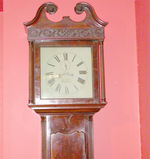 18th century mahogany Irish grandfather clock by Buchanan of Dublin with decorative fretwork relief.