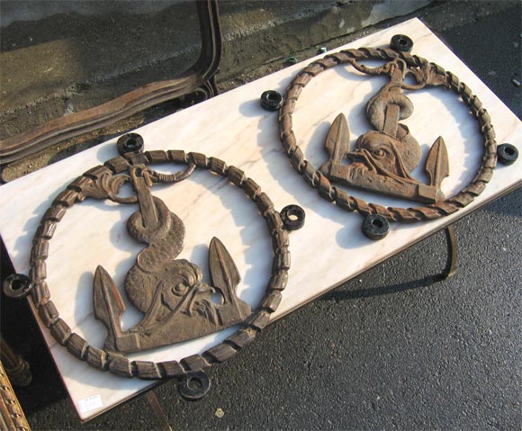 Cast iron marine signboards with anchor and dolphin decoration on both sides