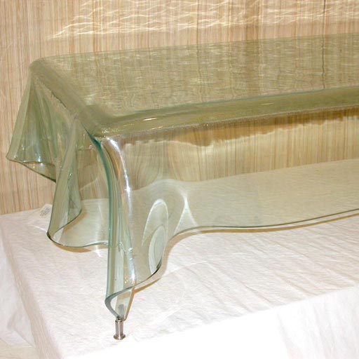 Murano glass table by Fontana Arte. Made in Italy circa 1970's.  Glass is shaped as a draped table. Shaped glass table is set on small stainless steel legs that are self leveling.
