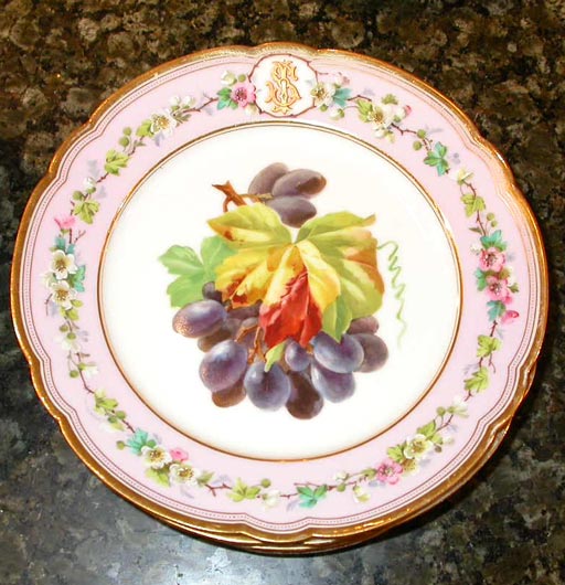 A 19th century Italian porcelain dessert service comprising 15 plates and 2 footed compotes; each piece with mauve border and different fruit decoration. Marked.