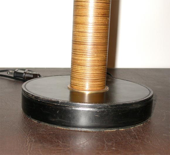 This a 1940's stacked leather lamp with a parchmont shade.  Its attributed to Dupre Lagon.