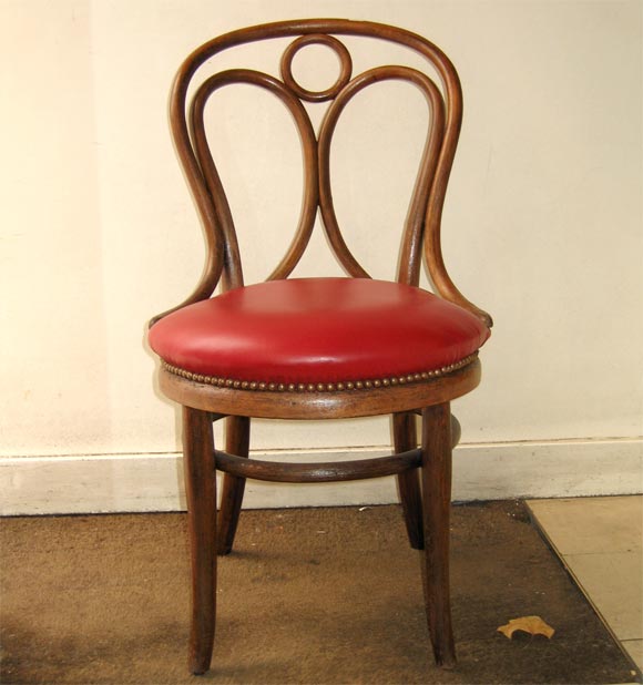 Two chairs by Thonet Brothers, listed in the 1888 sale catalogue, in curved beech and red leather.