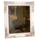 A carved wood mirror painted white from Provence