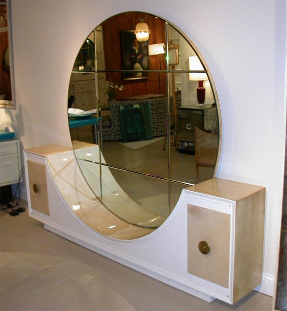 A very glamorous vanity. Designed by Samuel Marx and executed by Quigley in lacquer and parchment with a spectacular beveled glass, circular mirror. The epitome of Hollywood glamour.