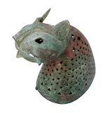 AN UNUSUAL AND RARE PERSIAN PATINATED-BRONZE HEAD OF A CAT