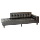 A Black Leather Biscuit-Tufted Chaise by William "Billy" Haines