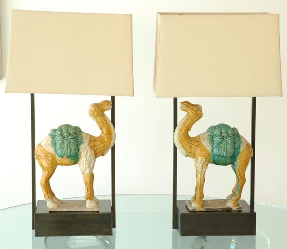 This lamp is based on the work of Billy Haines and features a Patinated Brass armature.  A pair of Chinese camel statues are featured and can be removed.  New linen Shades are included in the price.