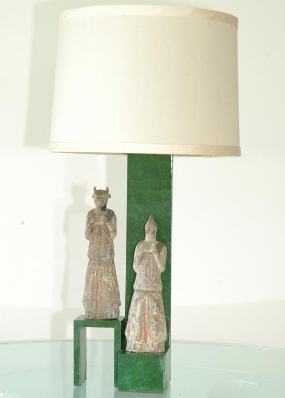 This lamp is very striking.  The finish to the body of the lamp is an oil-spotted Malichite green.  The figures are Chinese and I believe they represent the owners Chinese Zodiac signs.  This lamp was made for the Beverly Hills estate of Armand and