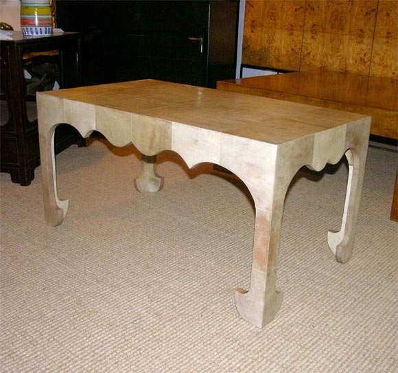 A nicely scaled ivory colored parchment cocktail table with decorative scroll motif edge in the manner of Jean-Michel Frank.