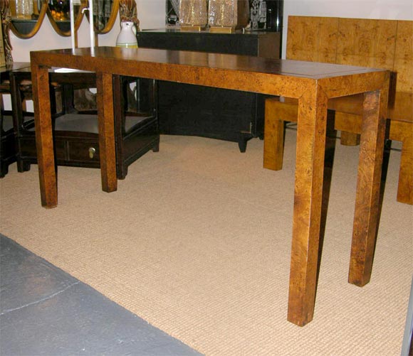 A parsons form console sofa table in Olive Ash Burl. American, circa 1960.