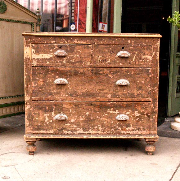 This attractive English chest of drawers retains its original grain painting.
