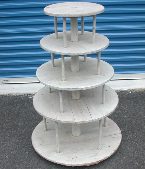 Tiered,painted wood display stand, with turned upright supports. Old grey paint.