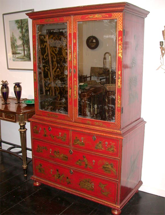 CIRCA 1710 A QUEEN ANNE RED JAPPANNED TWO DOOR MIRRORED FRONT CABINET ON CHEST WITH FITTED INTERIOR AND 2 SHORT & LONG DRAWERS IN THE LOWER PART;DECORATED THROUGH-OUT WITH CHINOISERIE