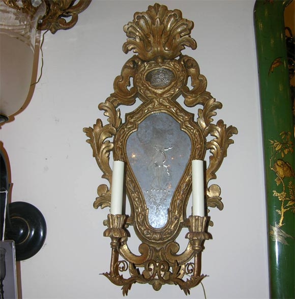 A pair of two light Italian carved and giltwood wall sconces