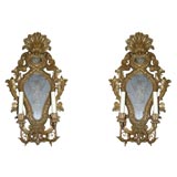 Antique A pair of two light Italian carved and giltwood wall sconces