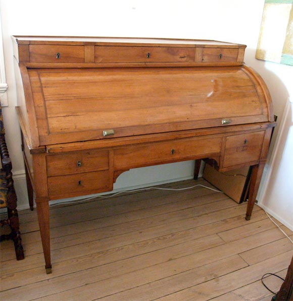 Elmwood with rouge leather top and small storage drawers.