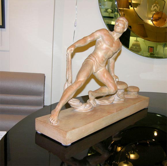 Sculpture depicting man and nautical theme,<br />
and is signed.