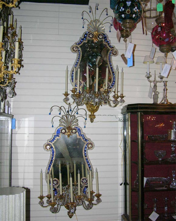 Pair of gilded iron and crystal nine light mirror back sconces
