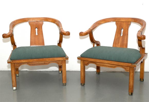 Pair of walnut asian chairs in the style of James Mont.  Extremely well crafted wtih solid brass detail and beautiful curved shaped arms.