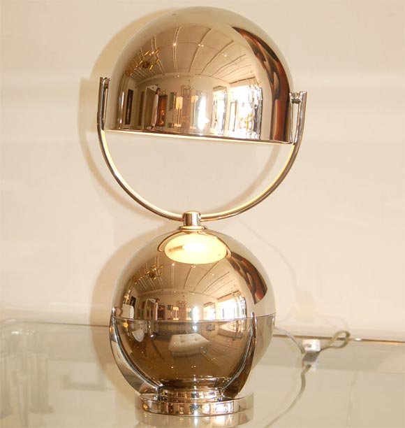 Art Deco desk lamp designed by Felix Aublet in 1925 of nickel-plated brass, moveable dome shade and orb body that swivels and tilts rests in three prong base