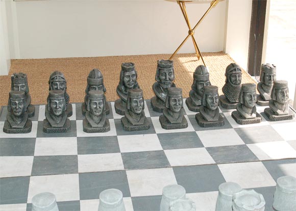 Very large and whimsical wooden chess board with concrete chess pieces.  <br />
Board : 65