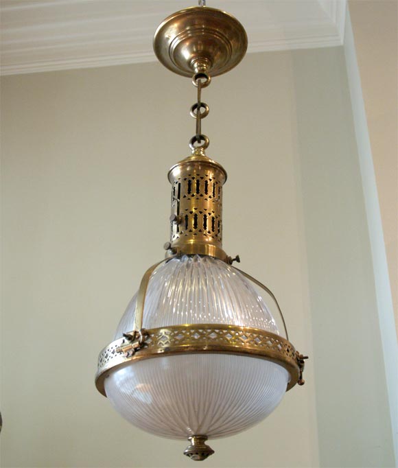 Pair of pierced brass and molded glass hanging lights.